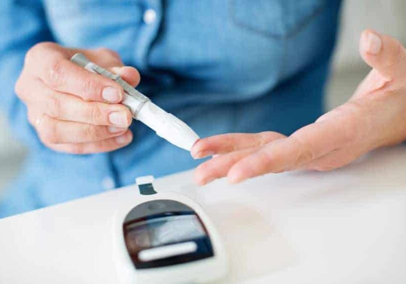 a woman pricking her finger for blood glucose test