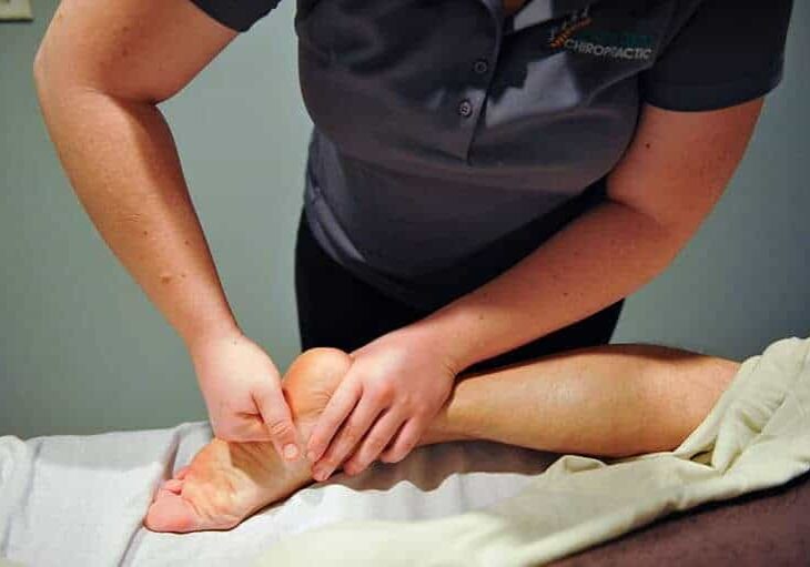 an Active Edge practiticioner applying massage techniques on a patient's foot at Active Edge in Columbus Ohio