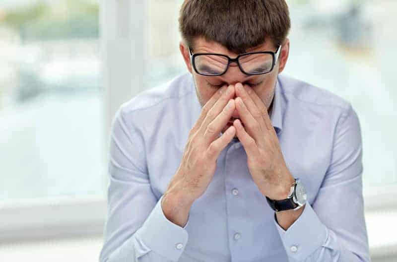 a male patient holding his nose bridge due to stress in Columbus Ohio