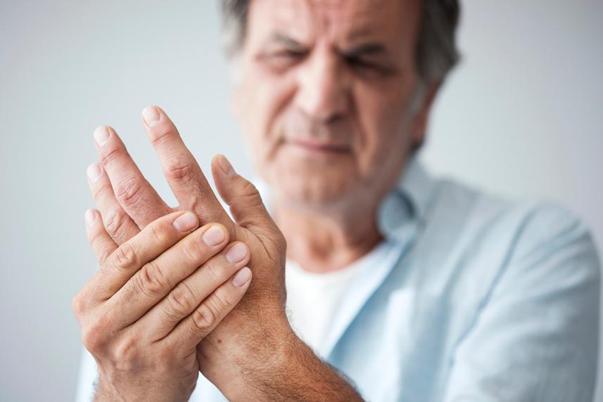 a male patient showing chronic pain symptoms in his hand