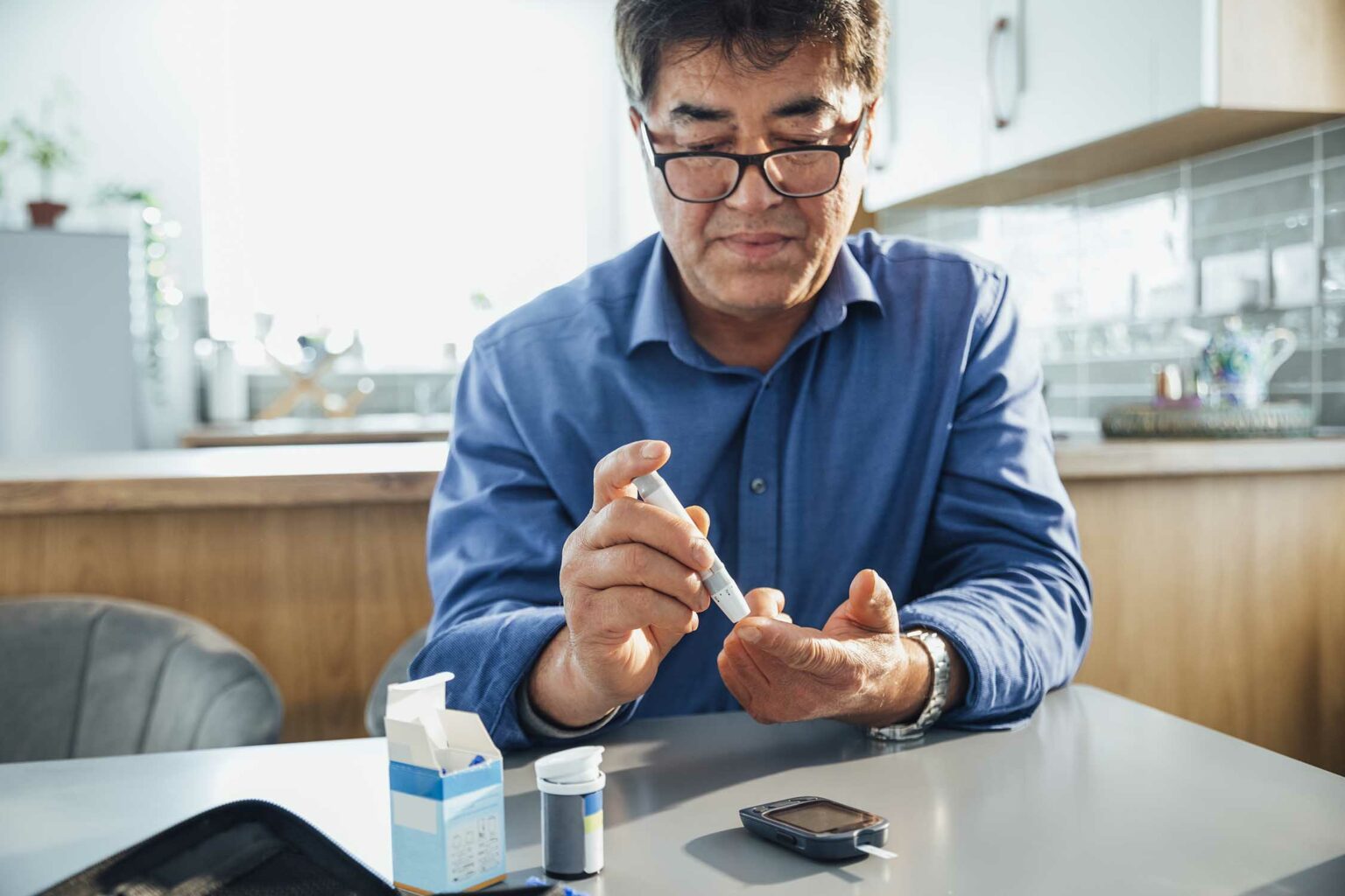 a male patient with Type 2 diabetes monitoring his blood glucose using a blood glucose meter