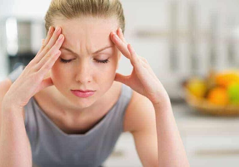 a woman with headache due to whiplash injury in Columbus Ohio