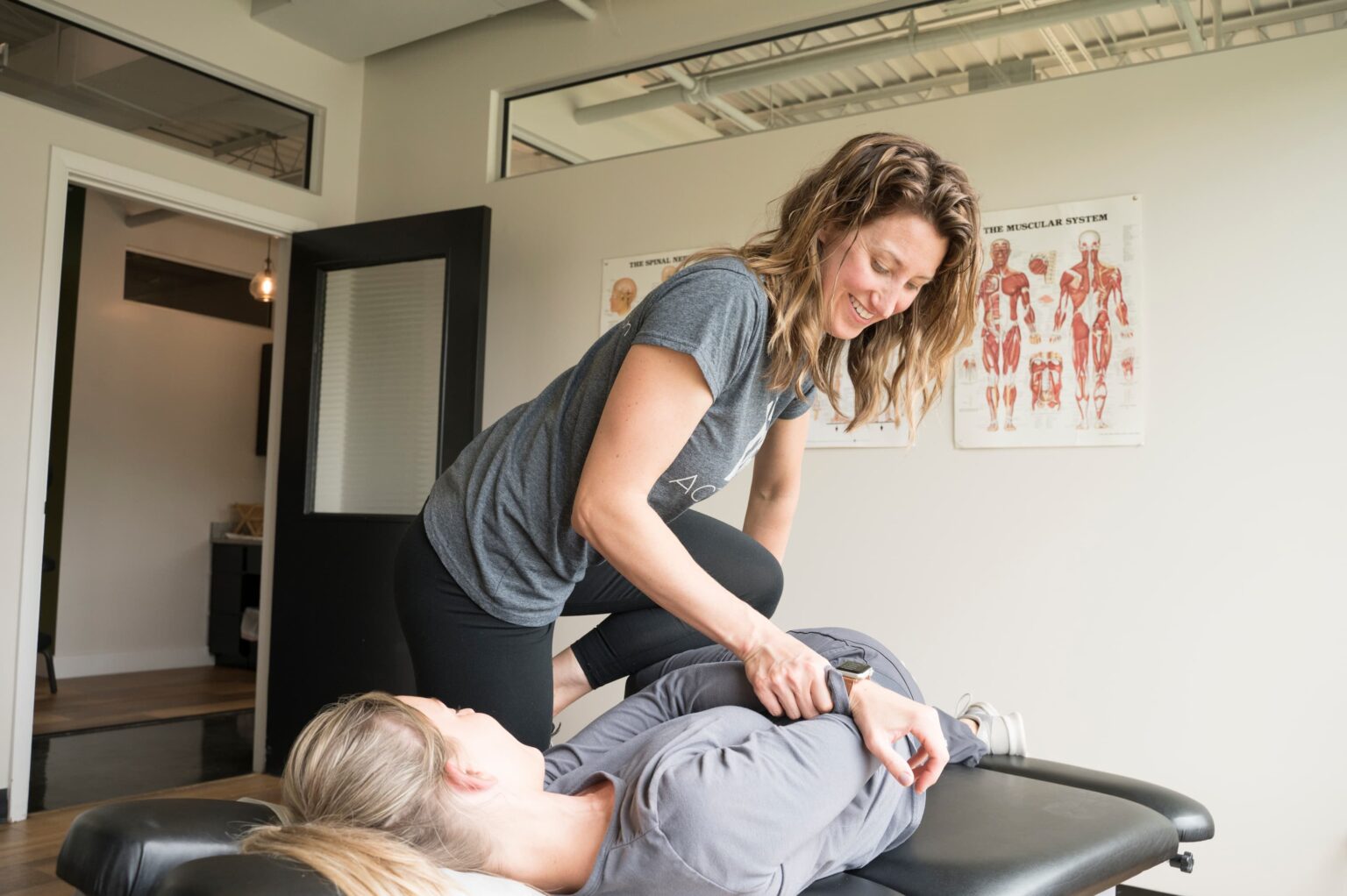 a female patient receiving back and neck pain relief from an Active Edge Chiropractor