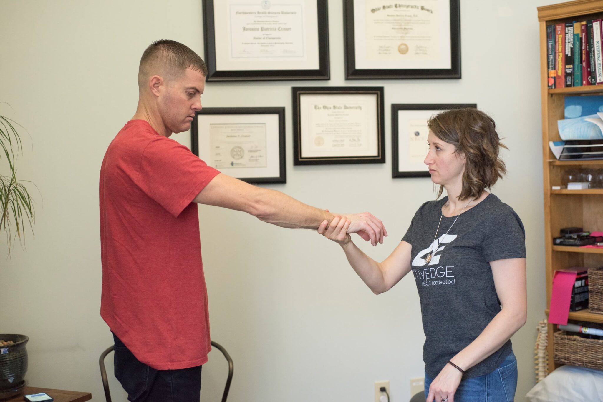 an Active Edge chiropractor assessing the body of a male patient in Columbus Ohio