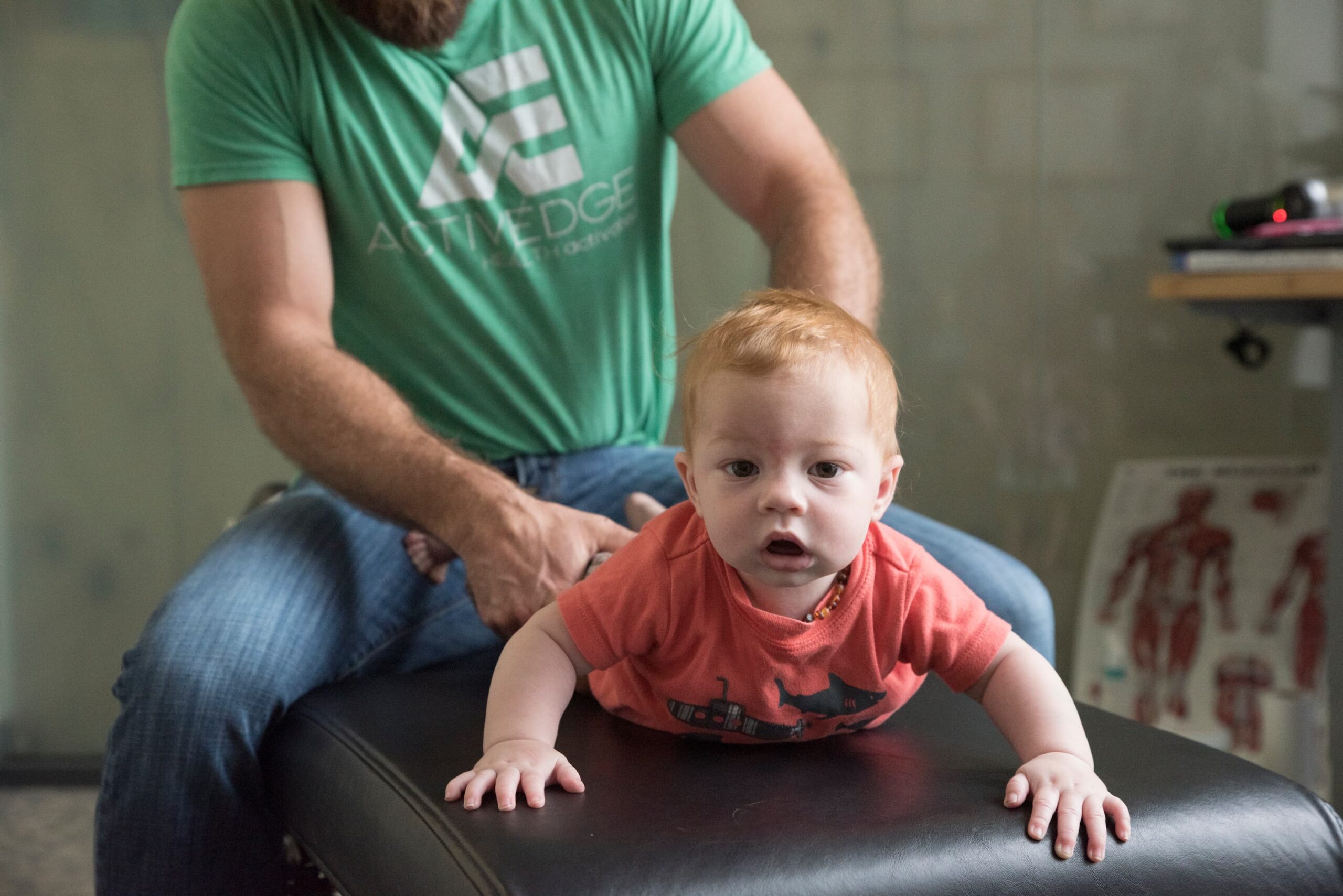 Dr Hensel performing a chiropractic adjustment on a toddler